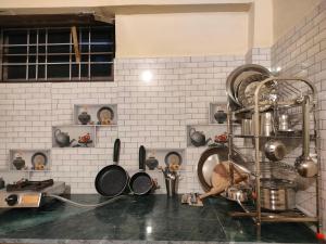 a kitchen with a bunch of pots and pans at Manu home stay in Almora