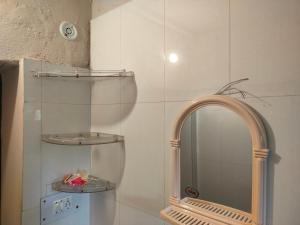 a bathroom with a mirror and a shelf and a sink at Manu home stay in Almora +209 photos