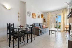a living room with a table and chairs and a couch at Residencial Los Pelicanos in Hospitalet de l'Infant