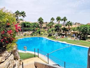 a large blue swimming pool next to a resort at The best Villa in Los Flamencos in Mijas