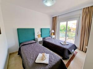 a hotel room with two beds and a window at The best Villa in Los Flamencos in Mijas