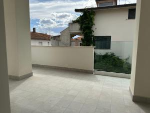 an empty balcony with a white wall and a courtyard at white B&B in Pagliare