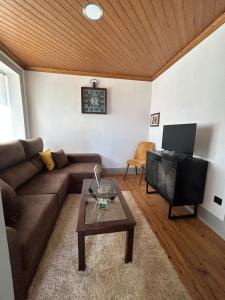 a living room with a couch and a coffee table at Domus Vila Maria Douro in Castanheiro do Sul