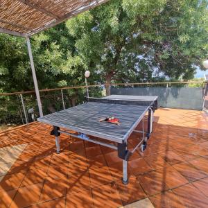 a ping pong table sitting on top of a patio at La Villa di Nino in Ustica