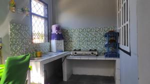 a small kitchen with a stove and a window at Babemhome in Karanganyar