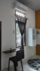 a room with a desk and a chair and a window at Babemhome in Karanganyar