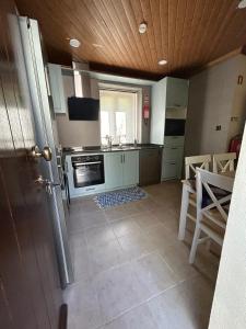 a kitchen with a sink and a stove top oven at Domus Vila Maria Douro in Castanheiro do Sul