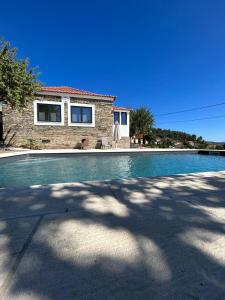 a swimming pool in front of a house at Domus Vila Maria Douro 