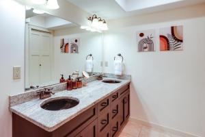 a bathroom with two sinks and a large mirror at Modern Bellingham Retreat Near Galbraith Mountain! in Bellingham +22 photos