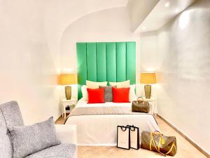 a bedroom with a bed and a green headboard at Heart Palace Fontana di Trevi in Rome