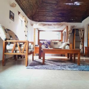 uma sala de estar com uma mesa e um sofá em Manuastro Breeze Villa - Diani Beach em Galu