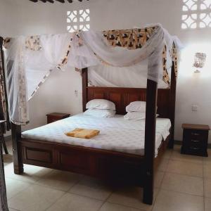 Postelja oz. postelje v sobi nastanitve Manuastro Breeze Villa - Diani Beach