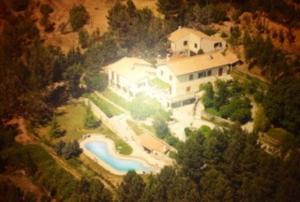 an aerial view of a large house with a swimming pool at Le Mas du Rat in Sainte-Cécile-dʼAndorge