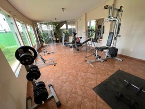 a gym with several treadmills and exercise equipment at Premier Garden Hotel in José Bonifácio