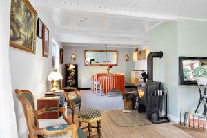 een woonkamer met een houtkachel en een eetkamer bij Frankerupvej 135, 4200 Slagelse in Slagelse