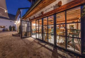 an empty building with windows and tables and chairs at CSELLO MÜHLE OSLIP, Eventlocation, Gastronomie & Nächtigung in Oslip