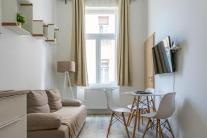 a living room with a couch and a table at Glam Downtown Apartments in Budapest