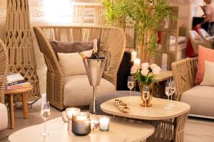 a living room with chairs and tables with wine glasses at JK Moulin Paradou in Paradou +27 photos