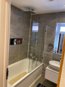 a bathroom with a shower and a toilet and a sink at Ruislip Guest House in Ruislip