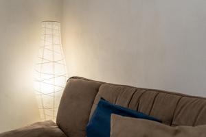 a lamp sitting next to a couch in a living room at Santa Maria degli Angeli Apartment in Naples
