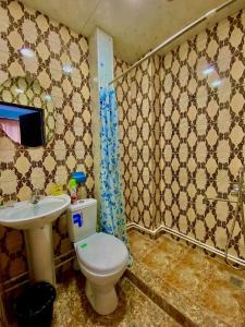 a bathroom with a toilet and a sink at Hotelvvv888 in Yerevan +55 photos