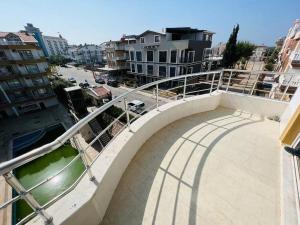 a balcony with a walkway in a city with buildings at altınkum da denize 150 m 4+1 dublex in Didim