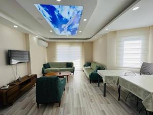 a living room with a ceiling with a skylight at altınkum da denize 150 m 4+1 dublex in Didim
