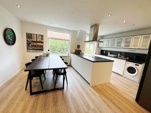 a kitchen with a table and a dining room at Aalborg city center newly renovated house in Aalborg