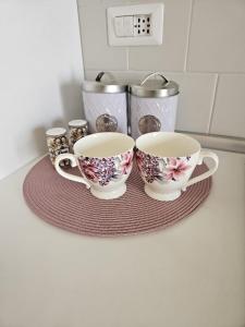 a group of three cups on a plate on a counter at Royal House Reggia in Caserta +4 photos