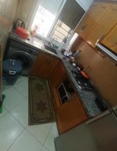 a kitchen with a sink and a stove top oven at Dayar arrid in Nador