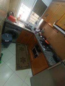 a small kitchen with a sink and a stove at Dayar arrid in Nador