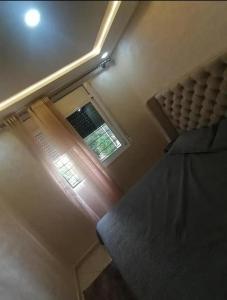 a bedroom with a window and a bed in a room at Dayar arrid in Nador