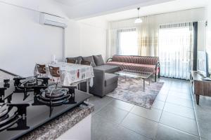 a living room with a couch and a stove at Vacation Flat w Pool Garden in Bodrum in Milas