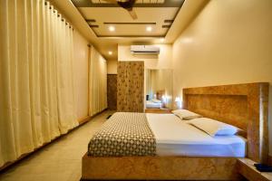 Postel nebo postele na pokoji v ubytování hotel saptarang residency panhala