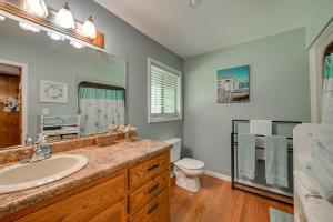 a bathroom with a sink and a toilet and a mirror at Cozy Dover Home with Boat Dock, Fire Pit and Deck! in Dover +28 photos