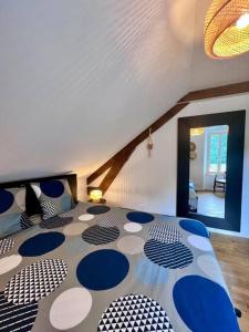 a room with a bed with blue and white at Charmante & Paisible Villa Platon - Jacuzzi & Jardin - Brive in Brive-la-Gaillarde