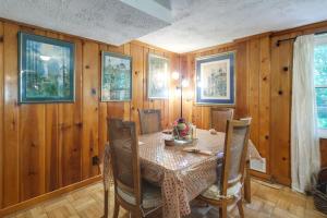 a dining room with a table and chairs and wooden walls at Bethesda Apartment and Yard about 9 Mi to D C in Bethesda