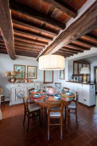 a dining room with a wooden table and chairs at Villa Eden Forte Dei Marmi With Private Infinity Pool in Santa Lucia