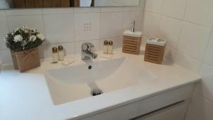 a bathroom sink with a white counter top at Casa do Pássaro in Galegos +72 photos