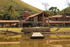 a house next to a body of water at Fazenda Capuava in Bananal