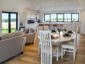 a kitchen and living room with a white table and chairs at Metfield in Great Yarmouth