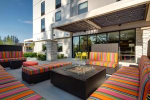 a patio with two couches and a fire pit at Home2 Suites By Hilton Marysville in Marysville