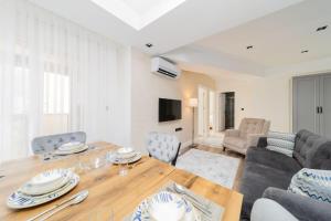 a living room with a wooden table and chairs at Flat in Antalya