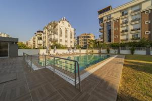 a swimming pool in a city with buildings at Flat in Antalya