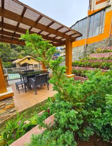 a patio with a table and a piano at Mirador Modern House - Walking distance to Lourdes Grotto in Baguio