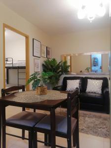 a living room with a table and a couch at 2BR Cozy Seaside Condo in Dumaguete in Dumaguete