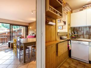 a kitchen with a table and a dining room at Appartement La Clusaz, 3 pièces, 8 personnes - FR-1-437-36 in La Clusaz