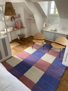 a room with two tables and a rug at Maison Marco in Espoey