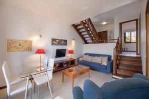 een woonkamer met een blauwe bank en een tafel bij Casa Maesa in Playa Honda