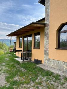 a house with a picnic table on the side of it at Kolasin - Hunting home in old village in Kolašin